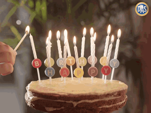 a birthday cake with candles that say " happy " on them