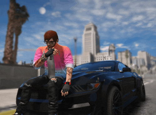 a man in a pink and blue shirt sits on the hood of a car