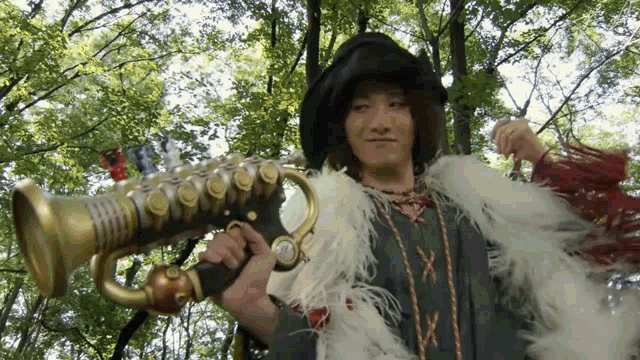 a man is holding a trumpet in a forest