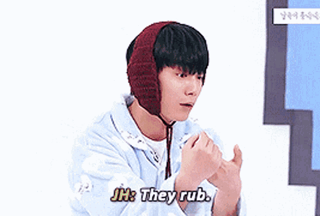 a young man wearing a knitted hat is saying jh they rub