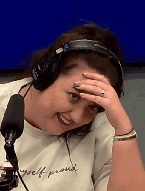 a woman wearing headphones and a t-shirt that says myself proud