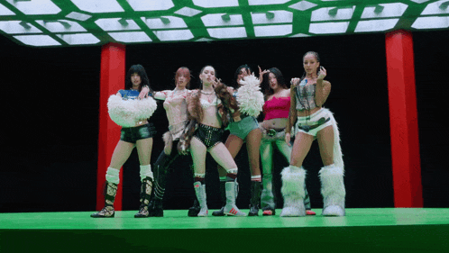 a group of women are standing on a stage and one of them is wearing a furry boot