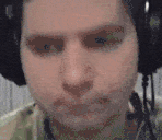 a close up of a man wearing headphones and making a face .