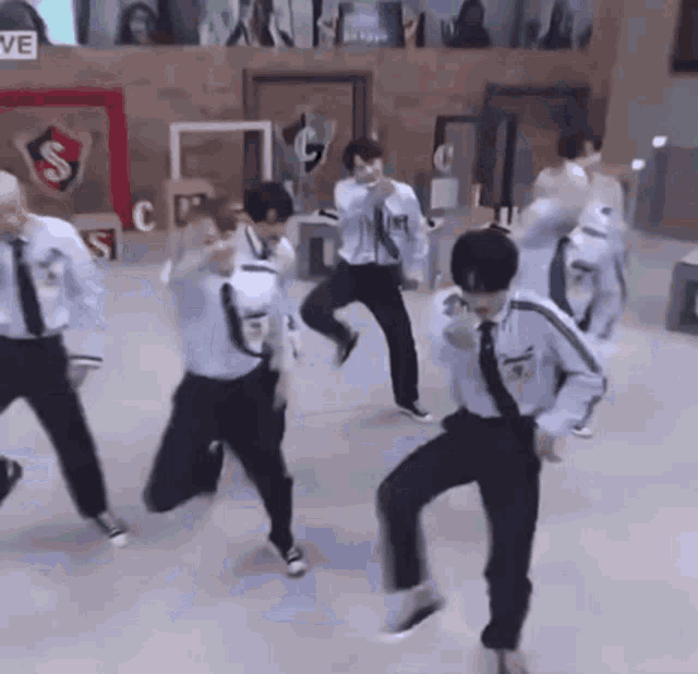 a group of people are dancing in a room .