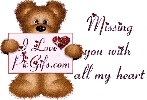 a teddy bear holding a sign that says missing you with all my heart