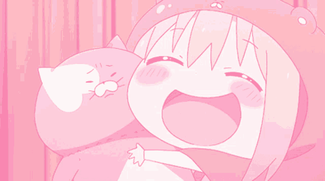 a girl in a pink hat is holding a cat