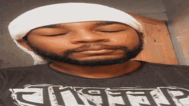 a man with a bandage on his head is wearing a shirt that says ' tiger ' on it