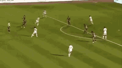 a group of soccer players are playing on a field with a banner behind them that says claro