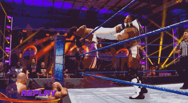 a wrestling ring with the word replay at the top
