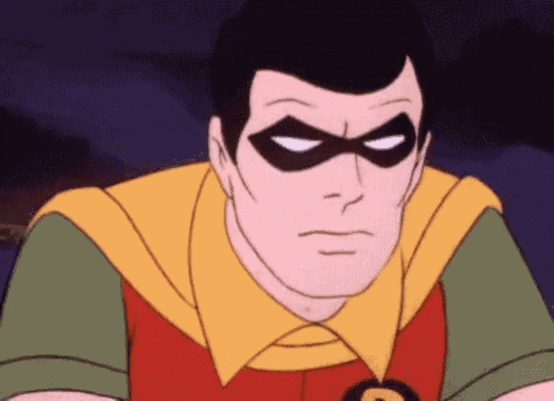a close up of a cartoon character wearing a mask and a red and yellow outfit .