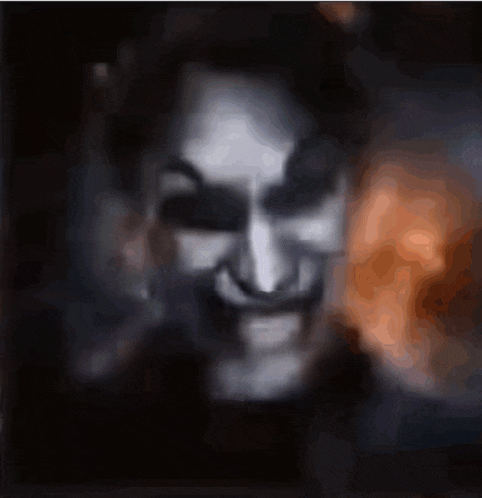 a close up of a person 's face with a scary smile on it .