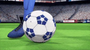 a person kicking a soccer ball on a field with a gatorade ad in the background