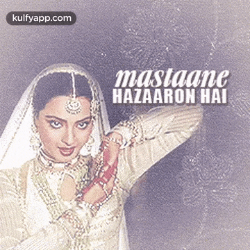 a woman in a white dress and veil is standing in front of a wall with the words mastaane hazaaron hai written on it