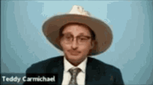 a man in a suit and tie is wearing a cowboy hat and glasses