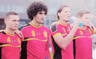 a group of soccer players in pink jerseys with the number 8 on the front