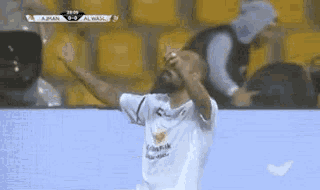 a soccer player is celebrating a goal with his arms in the air .