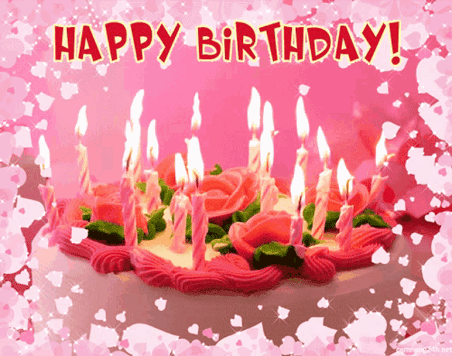 a pink and white birthday cake with candles and the words happy birthday