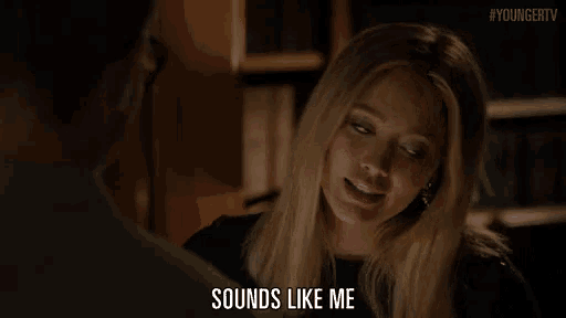 a woman is smiling while talking to a man and says " sounds like me "