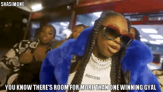 a woman wearing sunglasses and a blue fur coat with the caption " you know there 's room for more than one winning gyal "