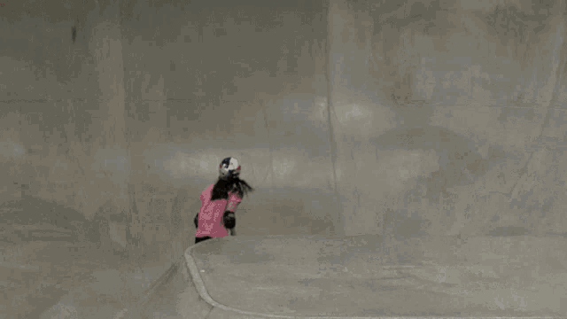 a person is doing a trick on a skateboard in a skate park with gb ff written on the walls