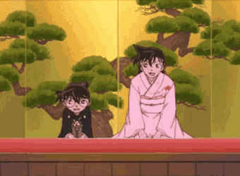 a girl in a pink kimono stands next to another girl