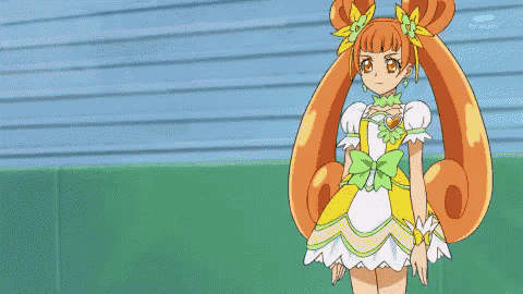 a girl in a yellow dress with a green bow on her head
