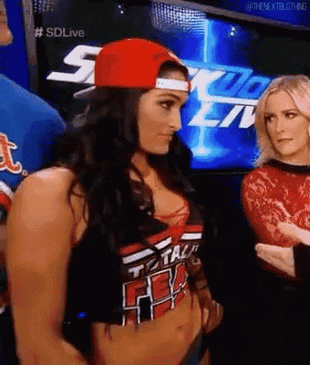 a woman wearing a red hat and a shirt that says total divas