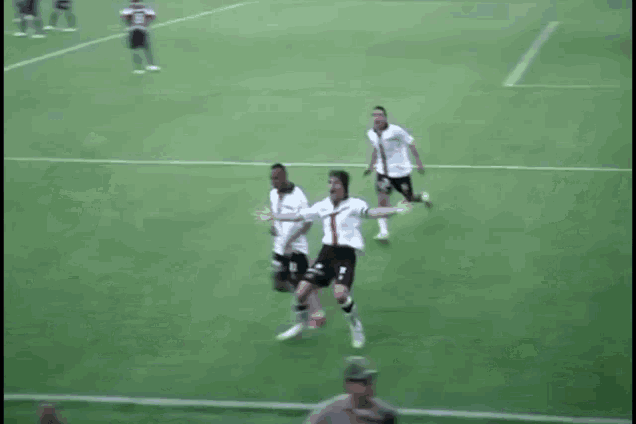 a blurry picture of a soccer game with a man laying on the ground