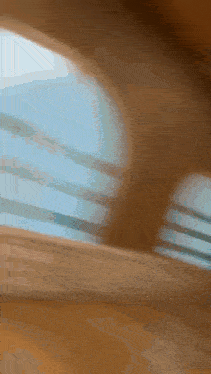 a blurred image of a window with a blue sky in the background