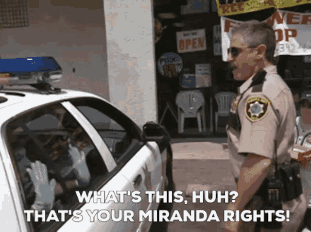 a police officer talking to a man in a car with the words " what 's this huh "