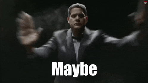 a man in a suit is saying maybe in a dark room