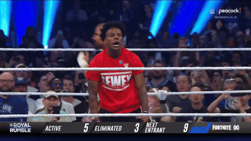 a man in a red shirt that says fwey stands in a ring