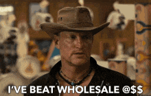a man in a cowboy hat is saying i 've beat wholesale @ $ $