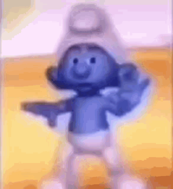 a smurf is holding a gun in his hand while dancing .