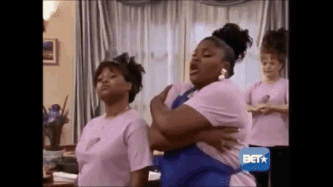 two women are standing next to each other in a living room .