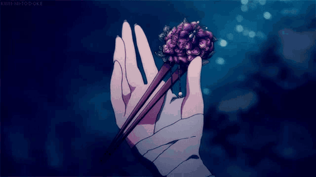 a hand with a bandage on it is holding a hair pin