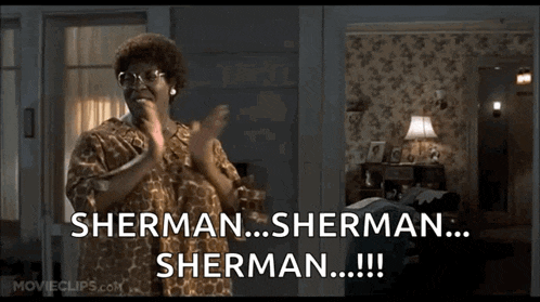 a woman is clapping in a living room and says sherman sherman sherman !!!