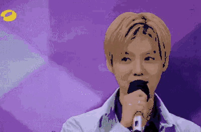 a pixelated image of a man holding a microphone