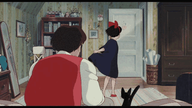 a girl with a red bow on her head is standing next to a man in a room