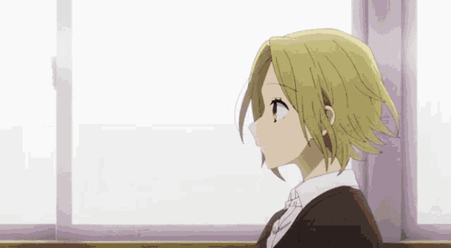 a girl with blonde hair looks out a window