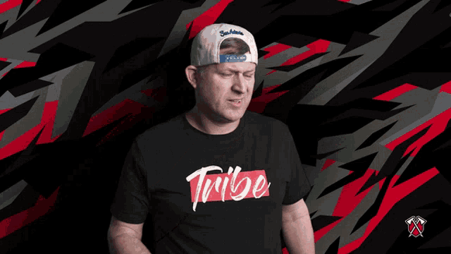 a man wearing a tribe t-shirt covering his mouth