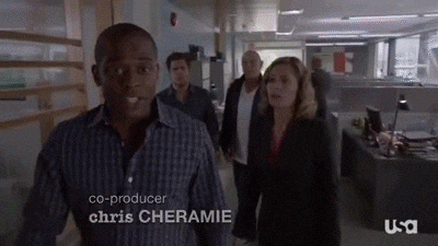 a group of people are walking down a hallway in an office with the name chris cheramie on the bottom .