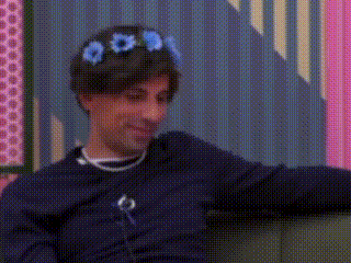 a man wearing a flower crown on his head .