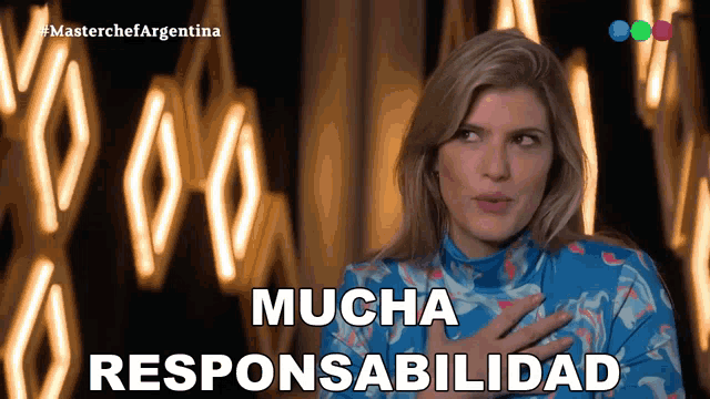 a woman in a blue dress says mucha responsabilidad in front of a bunch of lights