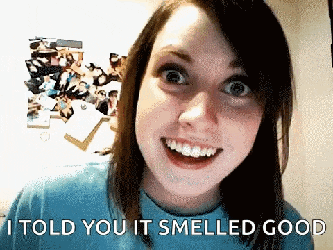 a woman is smiling and making a funny face while saying i told you it smelled good .