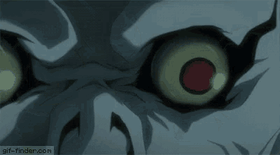 a close up of a skeleton 's eyes with glowing green eyes .