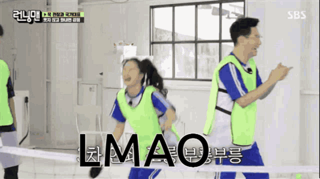 a man and a woman are running and the word lmao is on the screen behind them