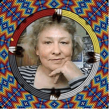 a woman is sitting in front of a colorful beaded frame with feathers .