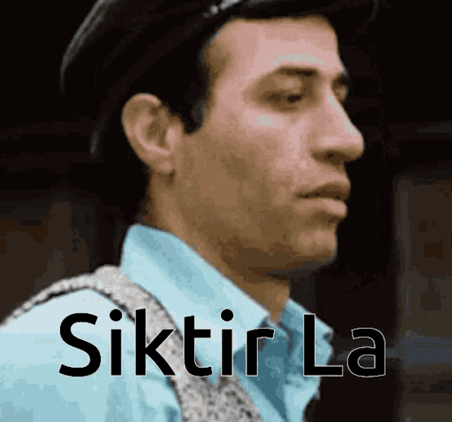 a close up of a man 's face with the words ' siktir la ' written below him