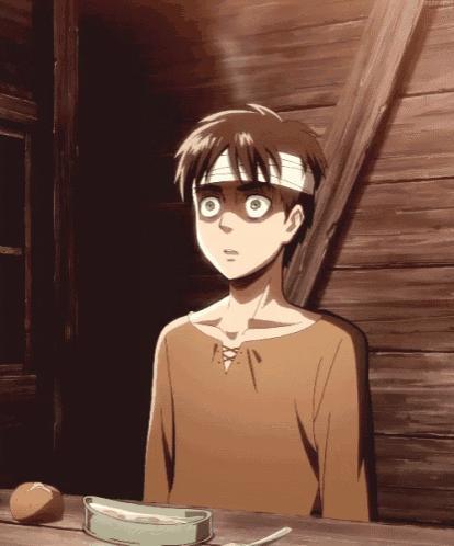 a boy with a bandage on his head sits at a table with a bowl of food